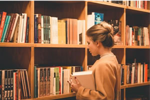 Photo of a girl and a bookshelf