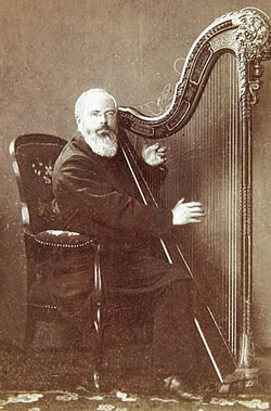 Johann Martin Schleyer playing the harp in 1888